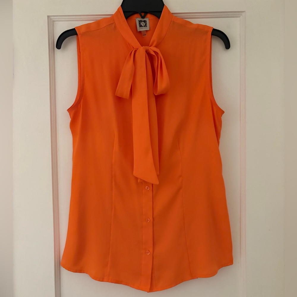Orange sleeveless blouse in medium